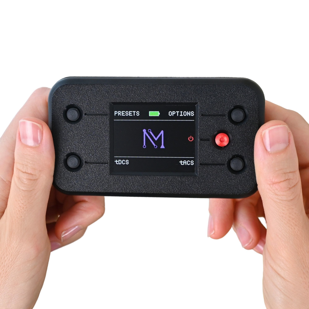 Black NeuroMyst Pro handheld stimulator with electrode leads and display